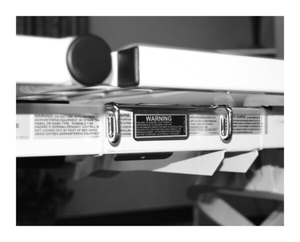 Joerns N516 drainage bag holder mounted under the EasyCare hospital bed deck