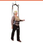 Hoyer standing harness sling by Joerns supporting a patient standing on a Hoyer lift 6-point spreader bar