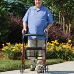 Walkabout Lite rollator in use on a garden path