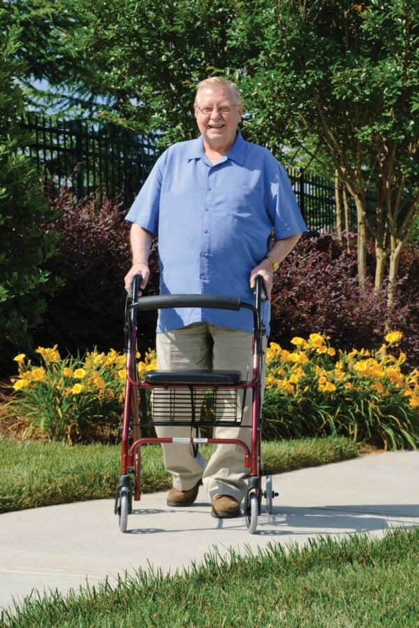 Walkabout Lite rollator in use on a garden path
