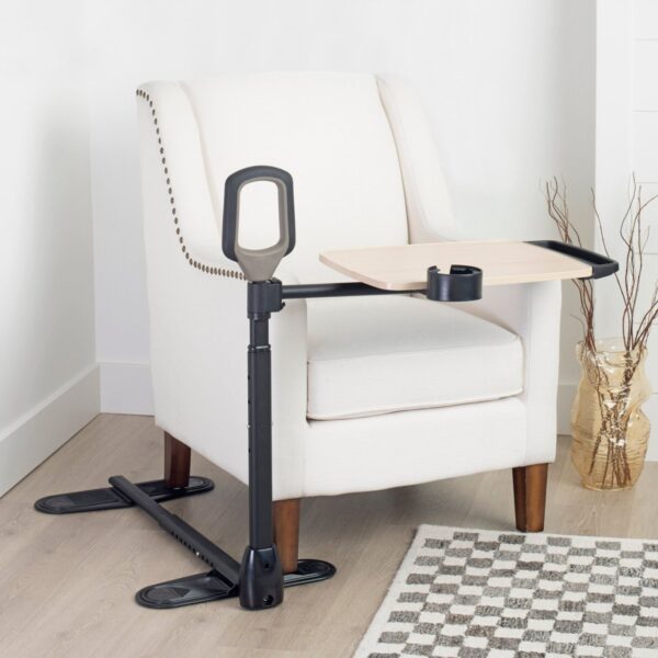 Stander Assist-A-Tray stand assist tray table with standing handle beside an armchair