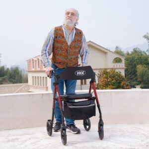 Senior man walking with a red VOCIC Z21 rollator walker