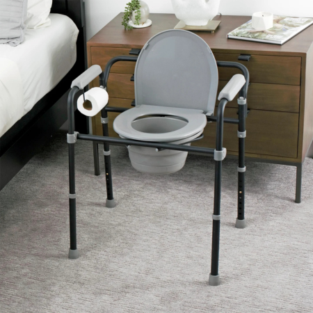 Stander Universal bedside commode for elderly with adjustable height, supportive armrests, removable bucket, and 3-in-1 commode chair design