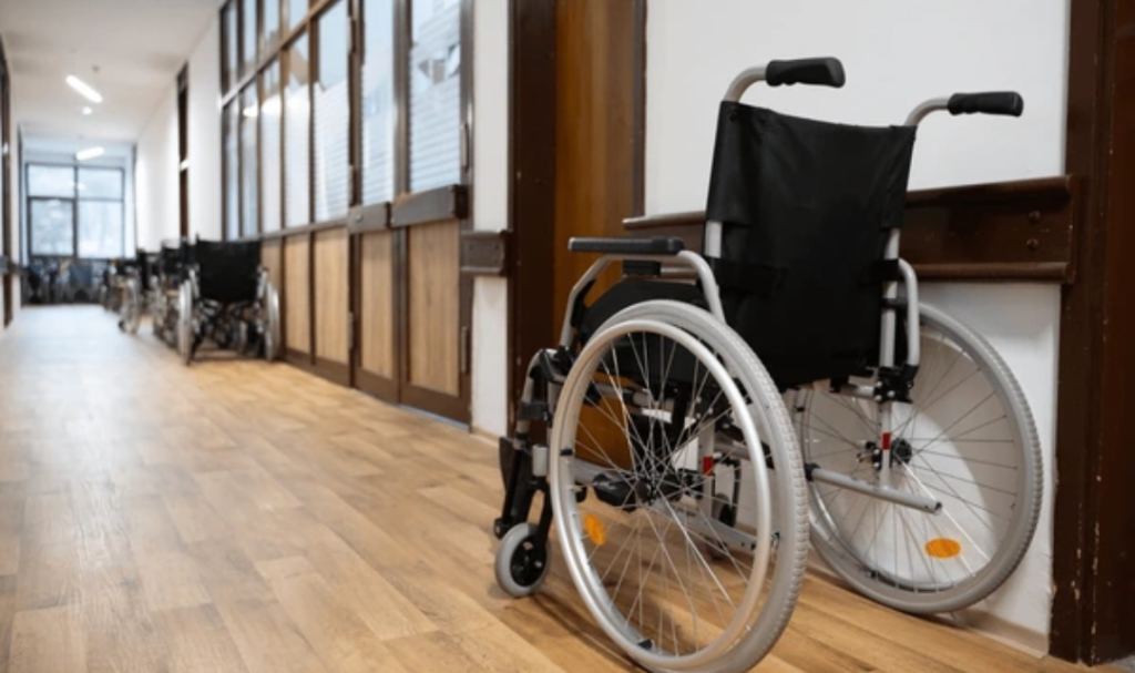 Best wheelchairs for hospitals positioned in a healthcare facility hallway for safe patient transport and institutional mobility support