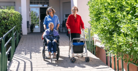 Seniors using rolling walkers outdoors, demonstrating the benefits of mobility aids for seniors in maintaining independence and stability.