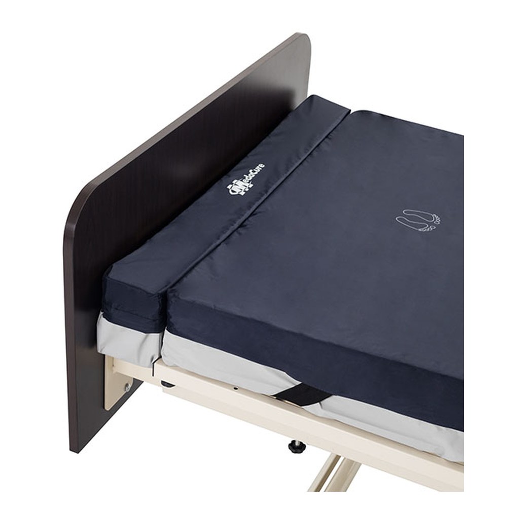 Medacure foam mattress extender gap filler at the foot of a hospital bed